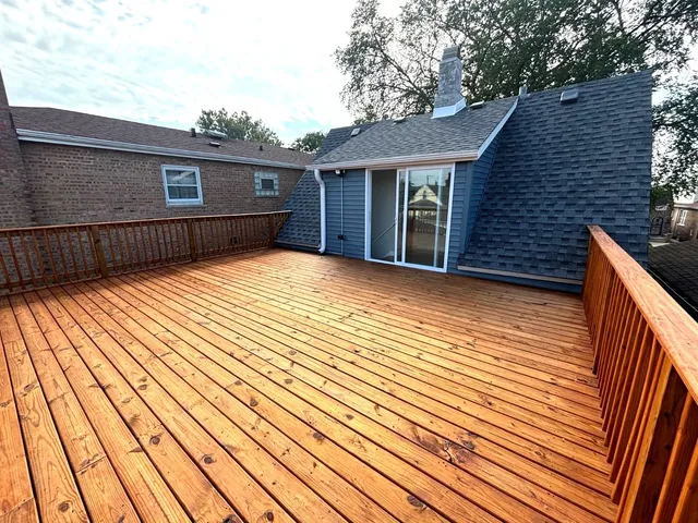 a view of backyard with a deck and wooden floor