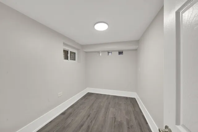 a view of room with wooden floor and fan