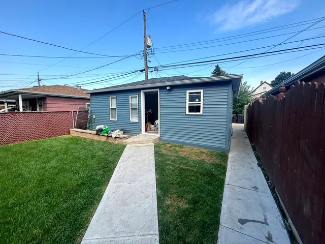 a front view of brick house with a yard