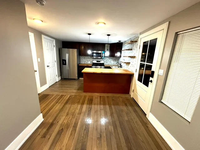 a view of kitchen with sink microwave and refrigerator