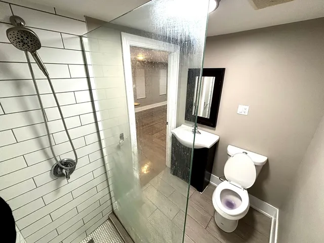 a bathroom with a toilet and a mirror