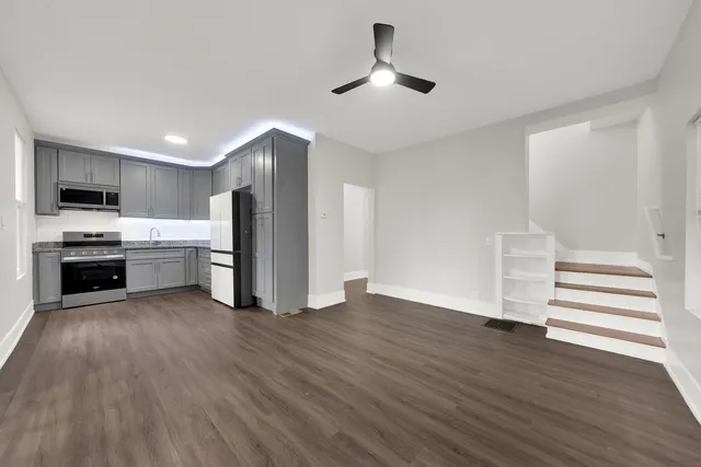 a kitchen with a refrigerator and a stove top oven