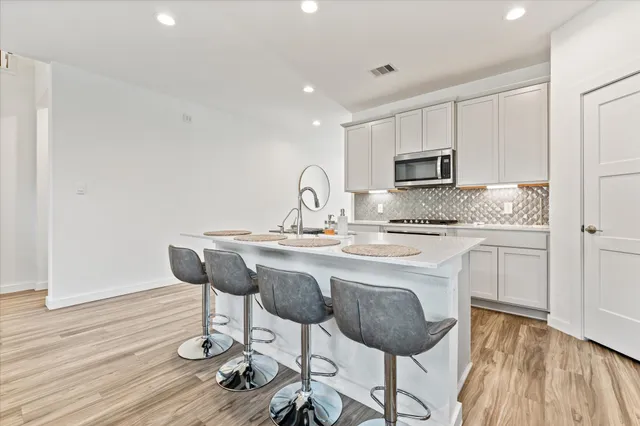 a living room with furniture and kitchen view