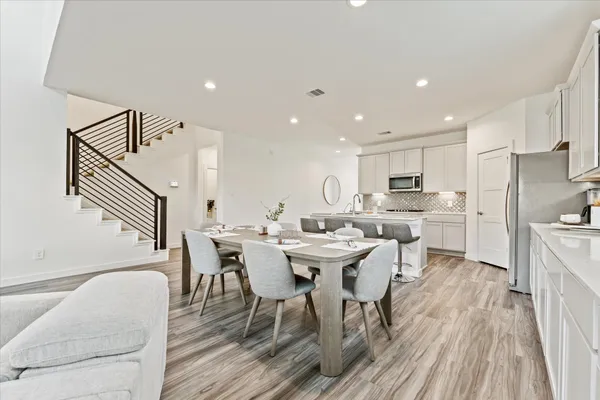a view of a dining room with furniture and wooden floor