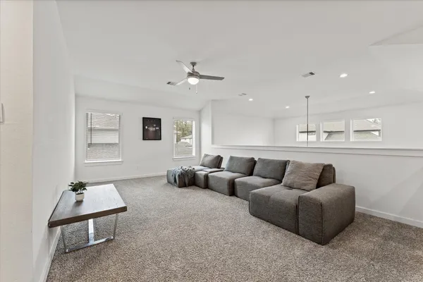 a living room with furniture and kitchen view