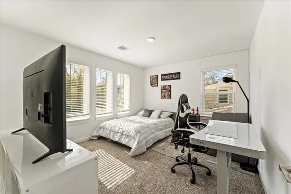 a bedroom with bed and a window