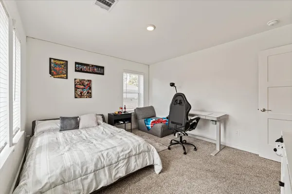 a bedroom with a bed and a chair