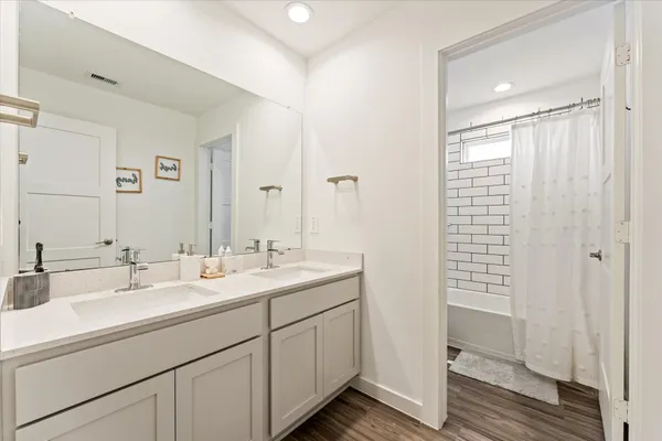 a bathroom with 2 sink and a mirror