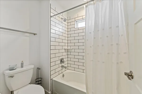 a bathroom with a toilet and shower