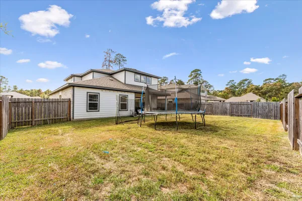 a swimming pool with some trees in the background