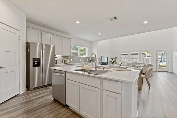 a kitchen with a sink stainless steel appliances and cabinets