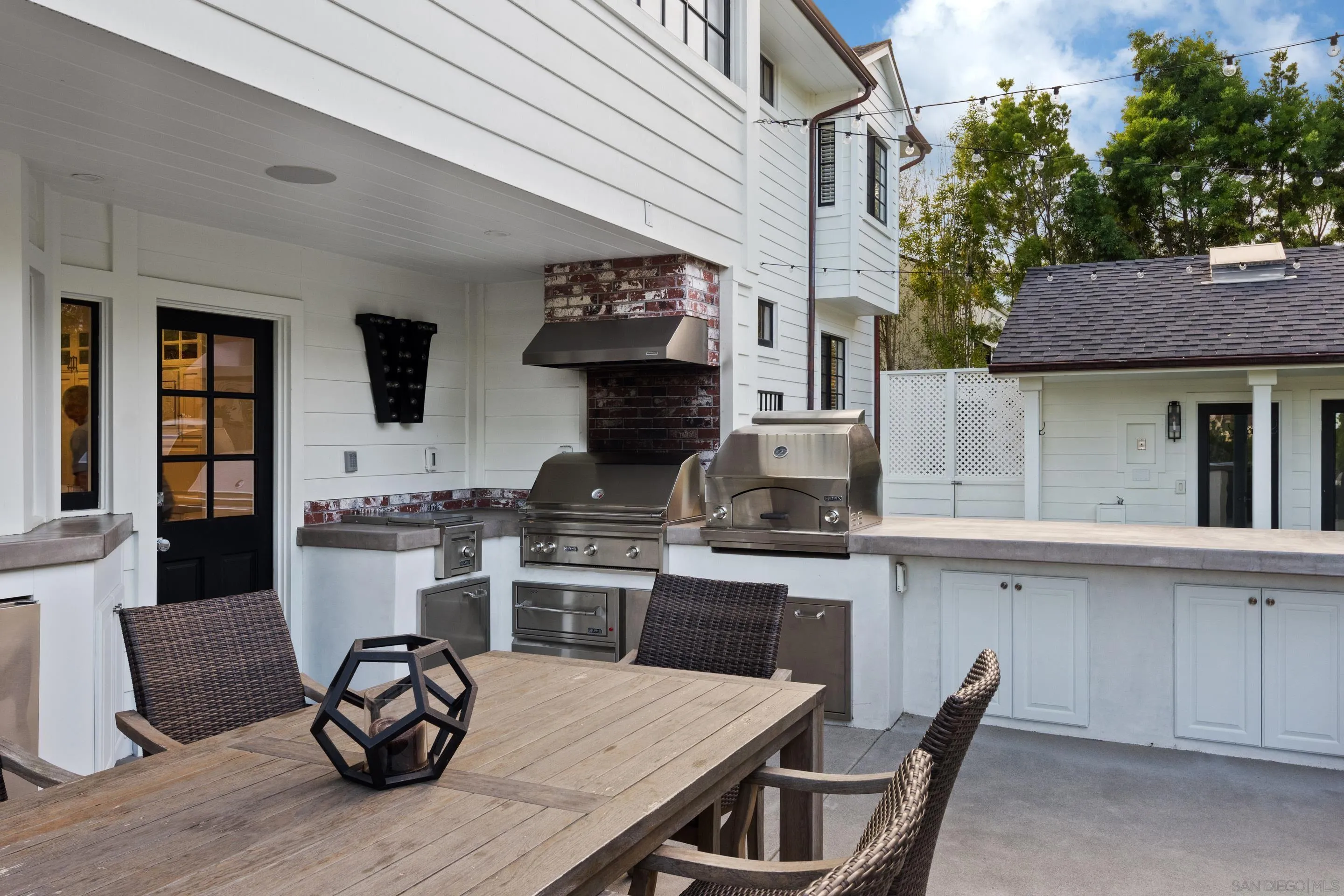 3530 Silvergate Place San Diego, CA 92106 - Photo 34 of 41 a kitchen with stainless steel appliances granite countertop a stove and white cabinets