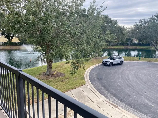 a view of swimming pool with a yard and large trees