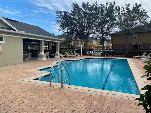 a view of a swimming pool with lounge chairs