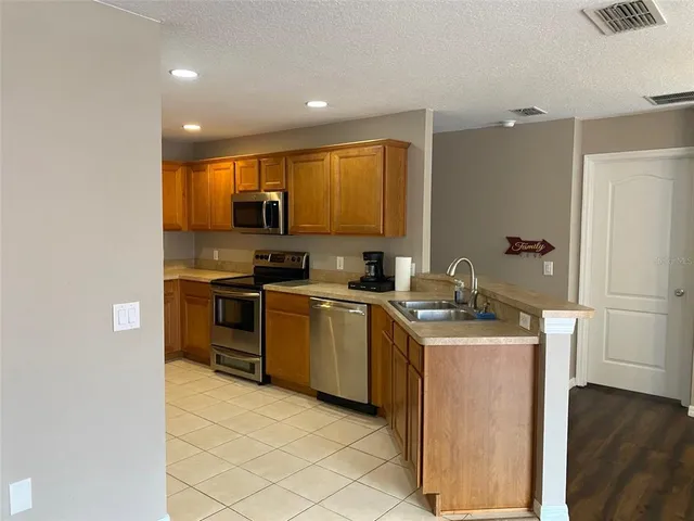 a kitchen with a refrigerator and a sink