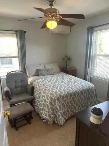 a bedroom with a bed and window