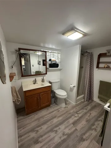 a spacious bathroom with a tub sink and mirror