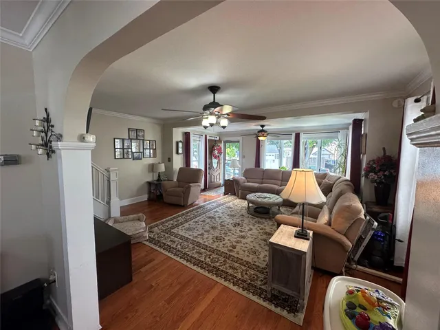 a living room with furniture and a chandelier