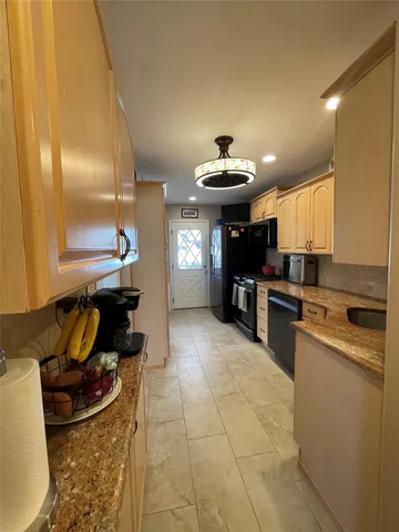 a kitchen with a sink appliances and cabinets