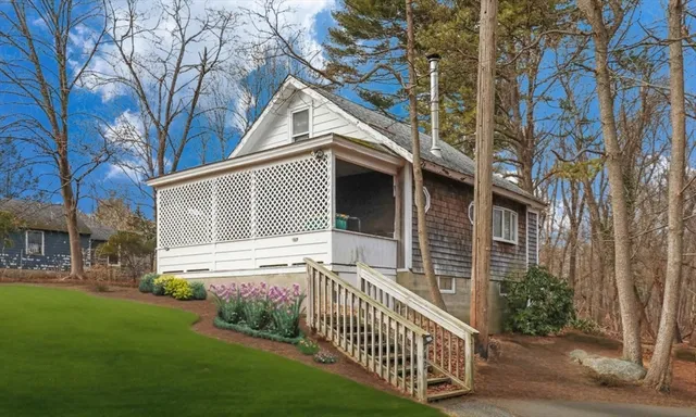 a view of a house with a yard and a porch
