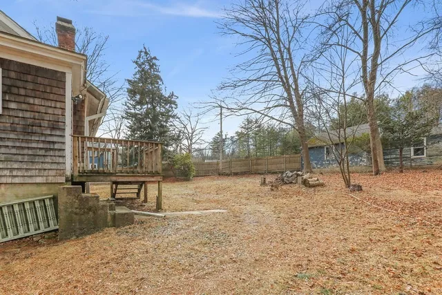 a backyard of a house with table and chairs