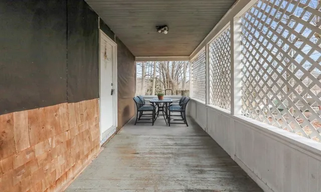 a balcony with chairs and table