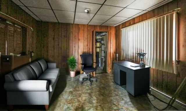 a living room with furniture a couch and large window