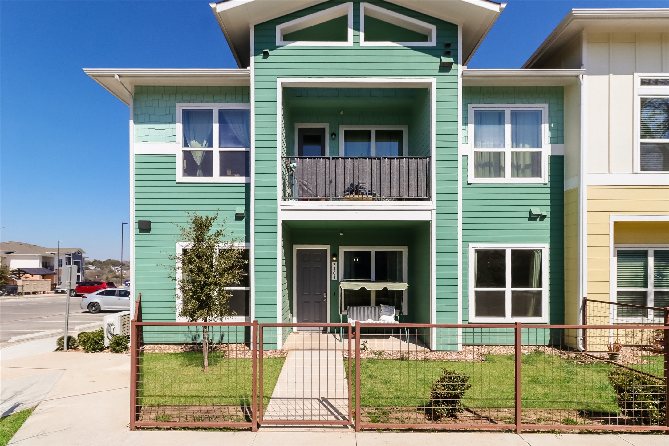 8601 West Gate Boulevard, Unit 7101 Austin, TX 78745 - Photo 1 of 16 View of front facade with a balcony, a fenced front yard, and a gate