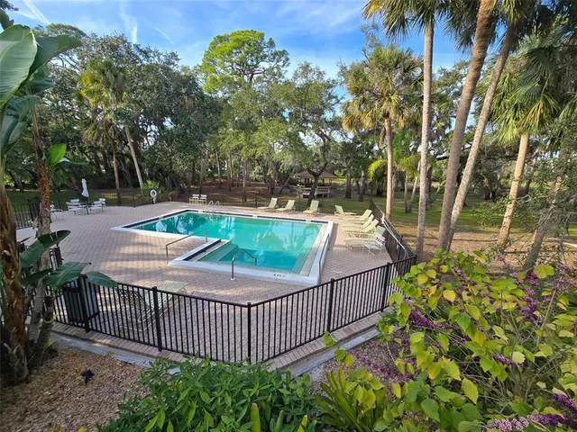 a view of a backyard with iron fence