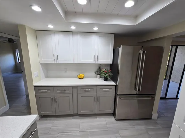 a kitchen with a refrigerator sink and cabinets