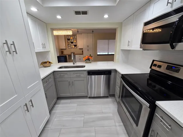 a kitchen with a sink stove and cabinets