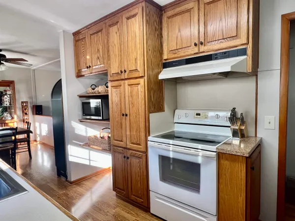 a kitchen with stainless steel appliances sink and large window