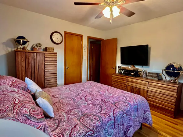 a bedroom with a bed a window and dresser