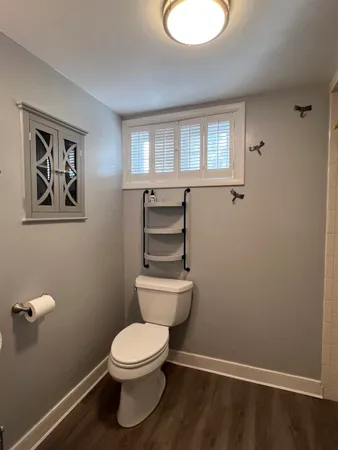 a bathroom with a toilet a sink and mirror