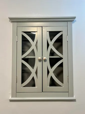 a view of a backyard with table and chairs plants and large trees