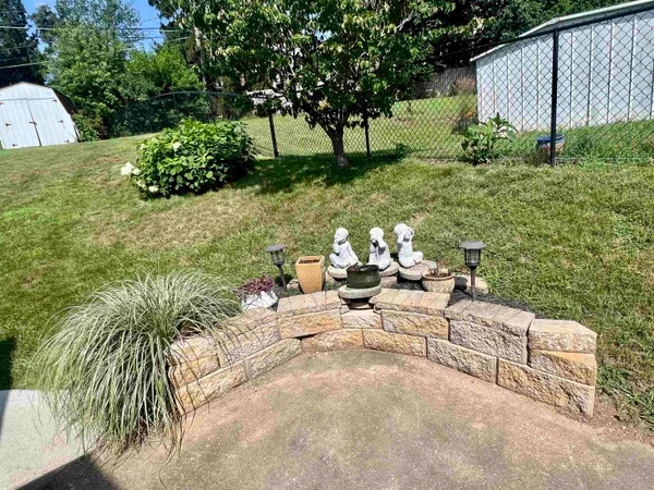 a view of a house with pool and sitting area