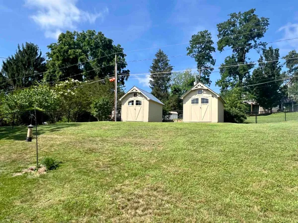 a view of a house with a wooden bench