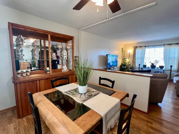 a view of a dining room with furniture window and wooden floor