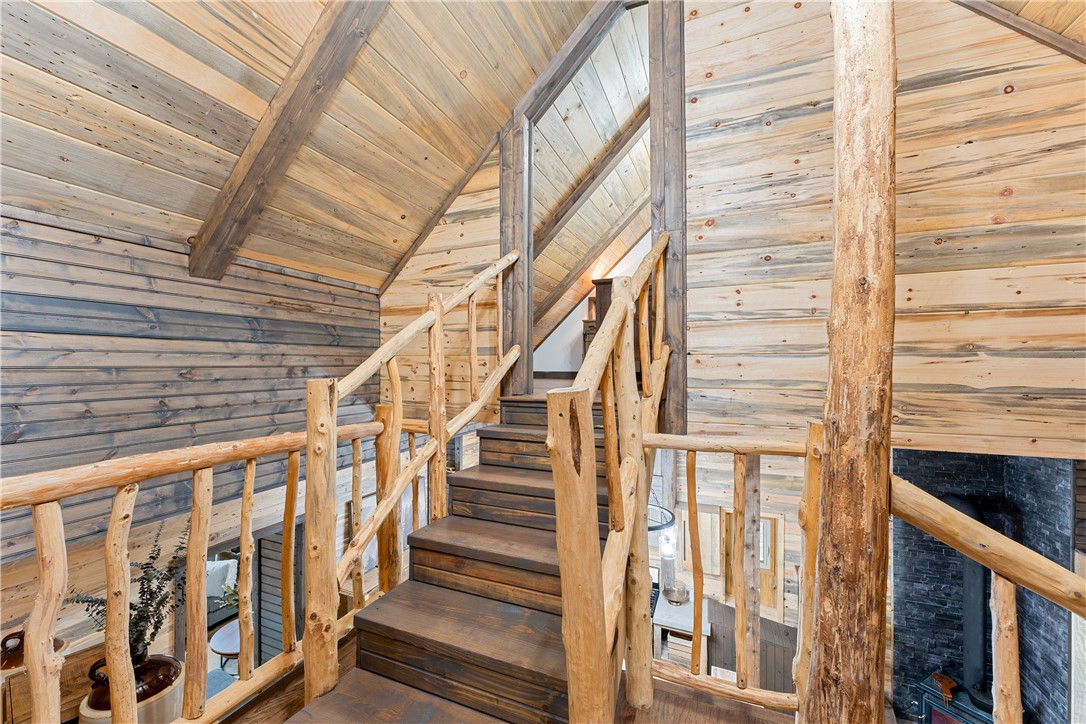 3931 Zack Road Marshall, AR 72650 - Photo 18 of 56 Staircase with a wooden ceiling with exposed beams and wood walls
