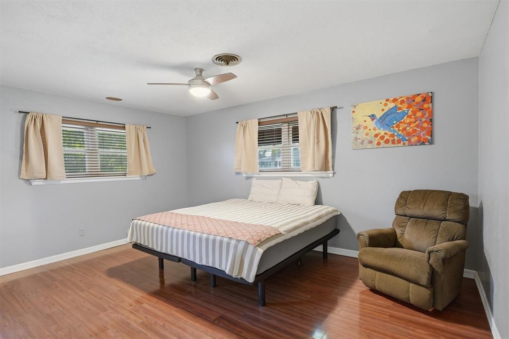 4105 Springbranch Drive Benbrook, TX 76116 - Photo 15 of 30 a bedroom with a bed wooden floor and window