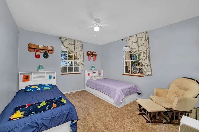 a bedroom with bed and a window