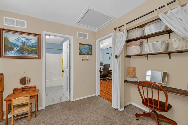 a view of a workspace with furniture and a cabinet