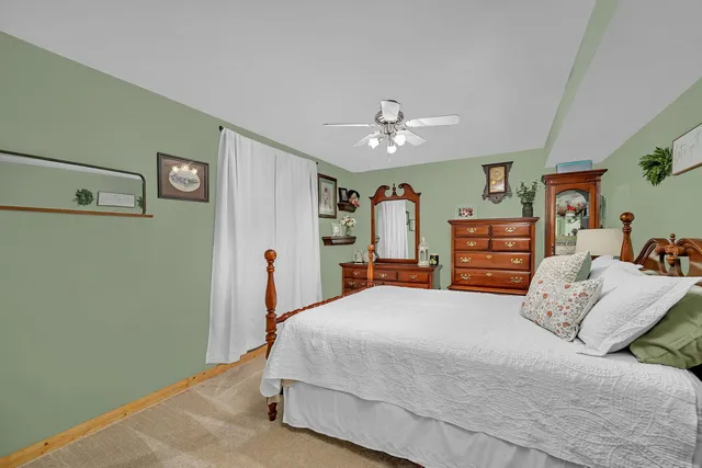 a bedroom with a large bed and a chandelier
