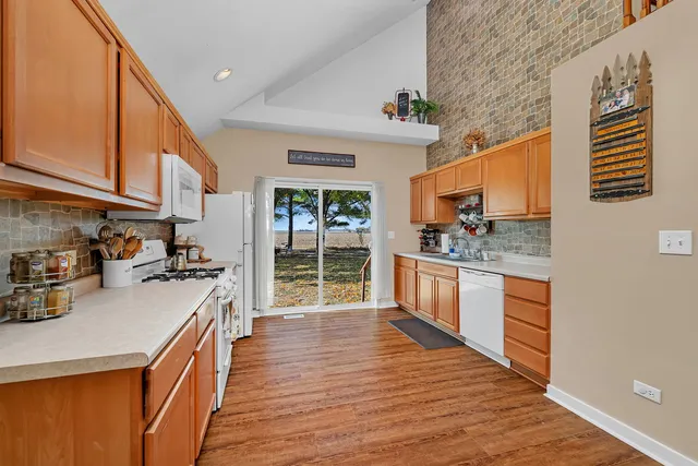 a kitchen with stainless steel appliances granite countertop a sink and cabinets
