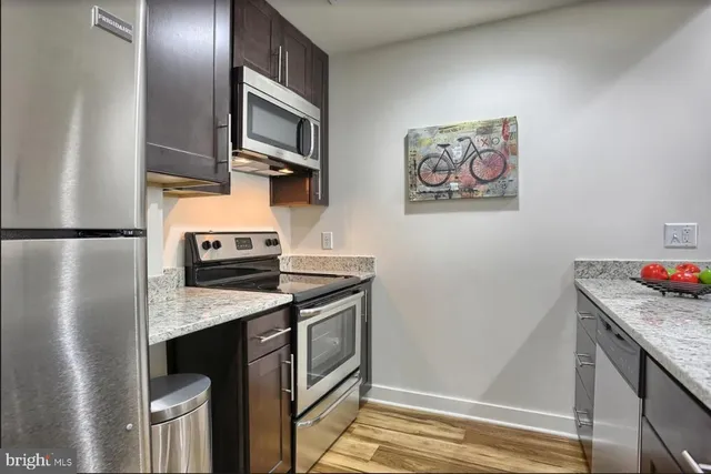 a kitchen with a stove and a refrigerator