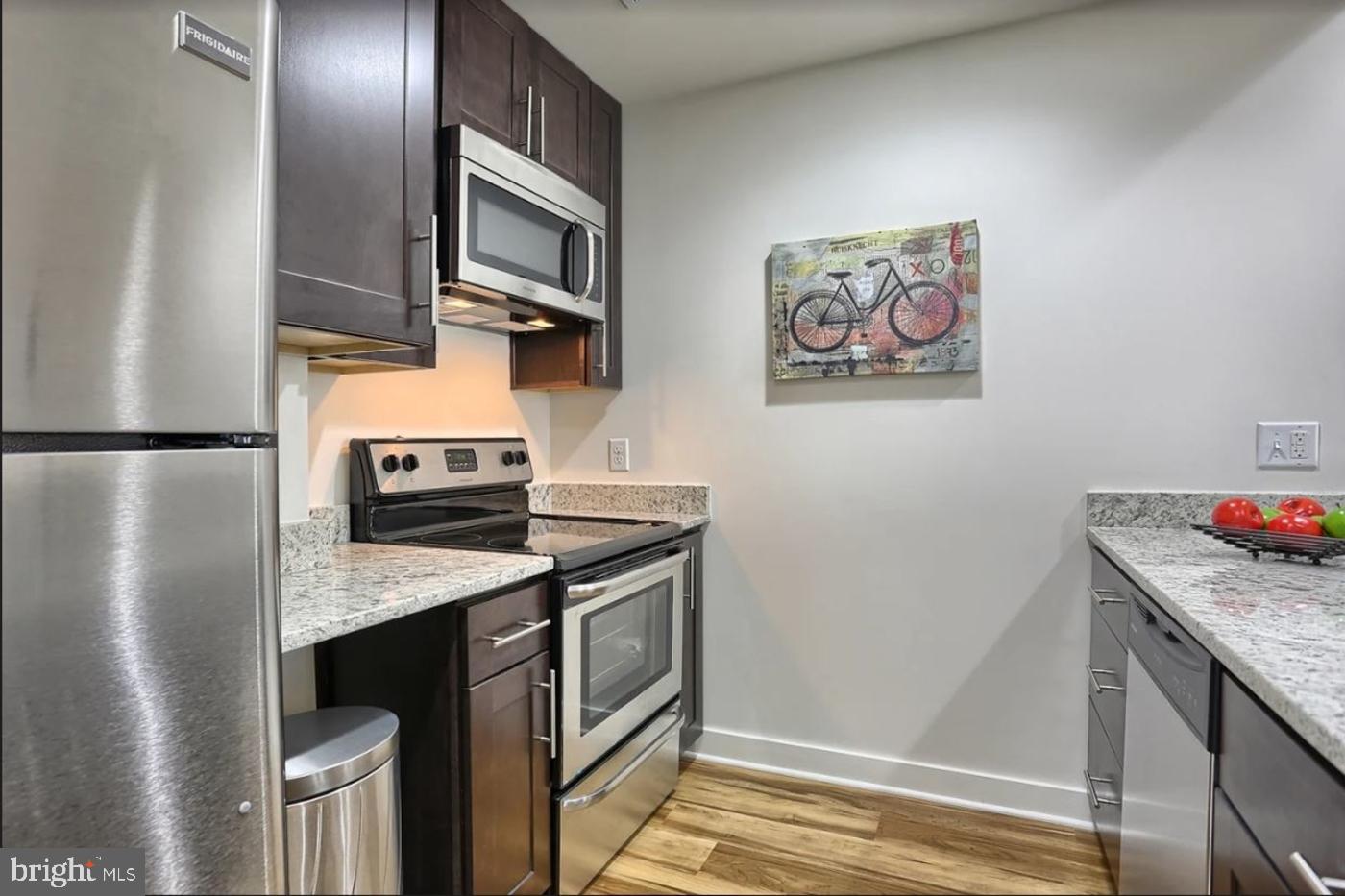 231 State Street, Unit 802 Harrisburg, PA 17101 - Photo 16 of 27 a kitchen with a stove and a refrigerator