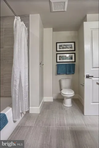 a bathroom with a toilet a sink and shower