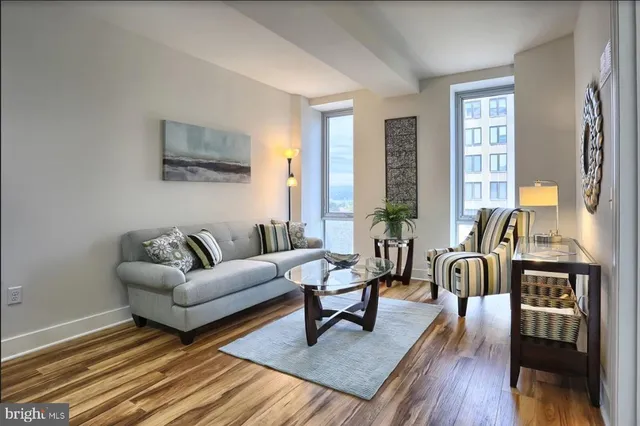 a living room with furniture and wooden floor