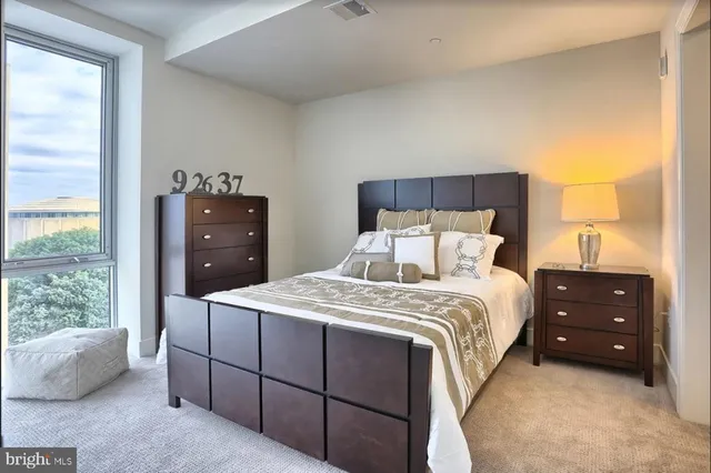 a bedroom with a bed and a window