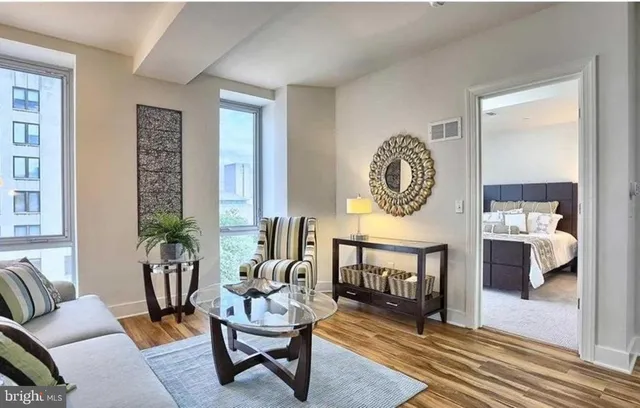 a living room with furniture a rug and a window